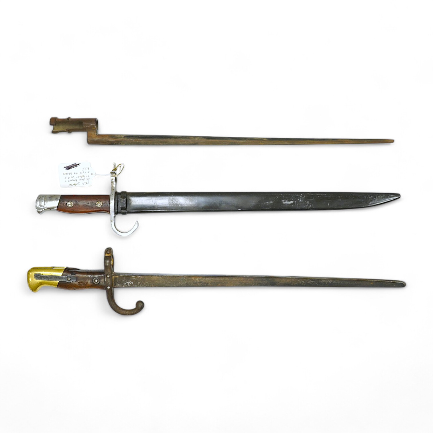 Three bayonets; a Japanese Arisaka bayonet, cleaned bright in its metal scabbard, a Nagant bayonet with quatrefoil blade, in good condition but missing scabbard, and a French Gras bayonet with the blade cut down. Conditi